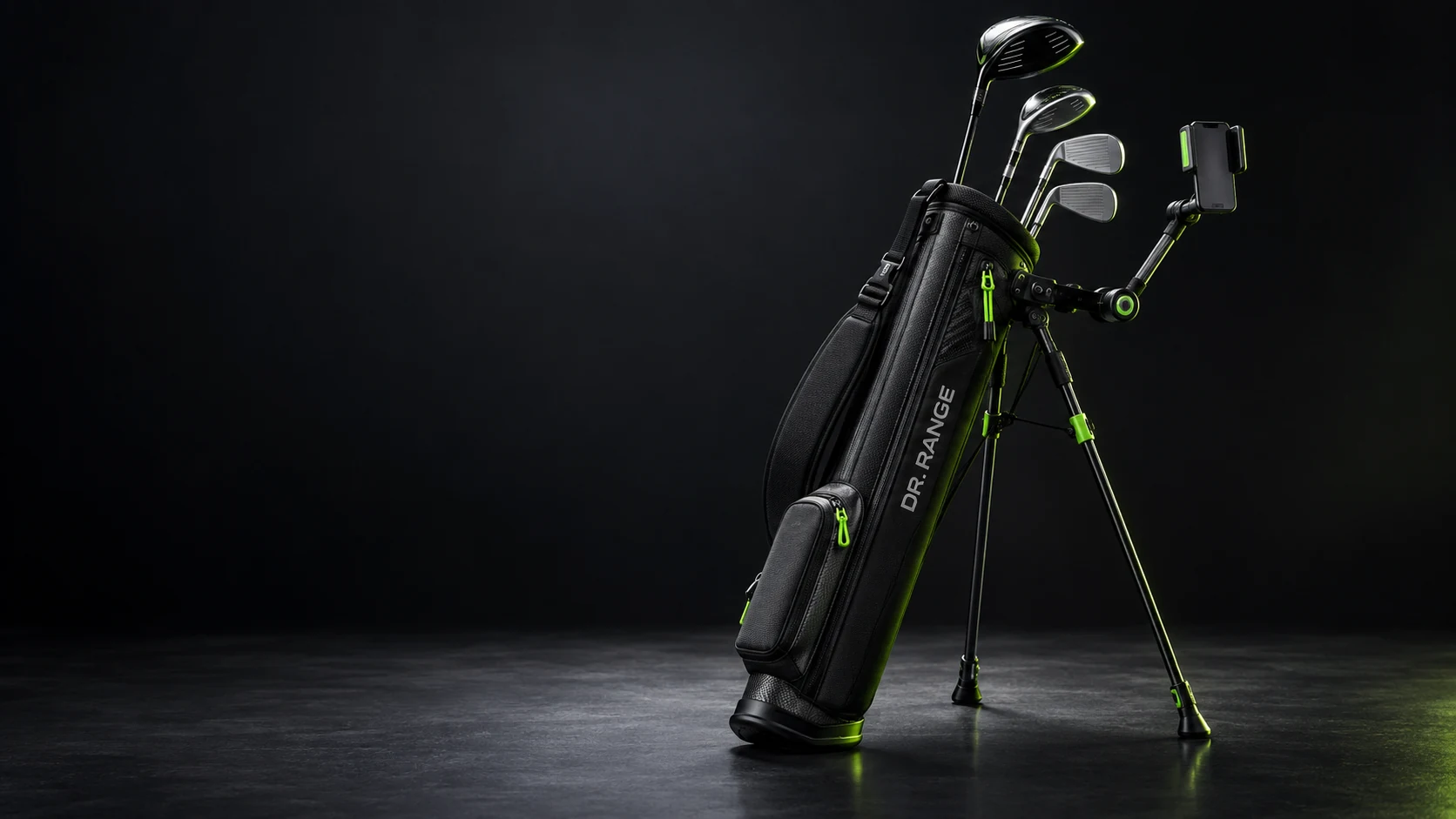 Design render of the Dr. Range Practice Carry: a black stand bag with green trim and DR. RANGE lettering, holding four clubs, standing on deployed legs with a phone mounted on the Range View arm.